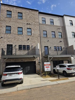 Stylish three-story townhomes featuring private balconies and garage access in Skyview On Broad by Kittle Homes (Sugar Hill, GA).