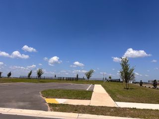 Open space with clear skies and new walkways in Scenic Terrace by Taylor Morrison, Lake Hamilton, FL.