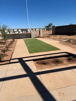 Modern landscaped area with a paved path and grass in Hawes Crossing: Discovery by Lennar (Mesa, AZ).