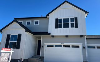 A modern home with crisp white siding in Crossway at Second Creek by Richmond American Homes (Commerce City, CO).