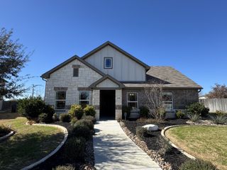 A charming stone and brick home with landscaped garden in Cloud Country by Brightland Homes (New Braunfels, TX).
