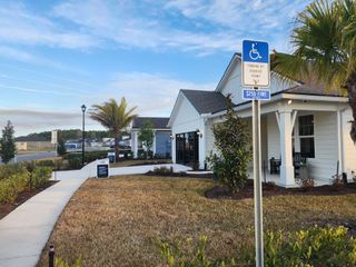 A charming modern farmhouse-style home with lush landscaping in Hyland Trail by Pulte Homes (Green Cove Springs, FL).