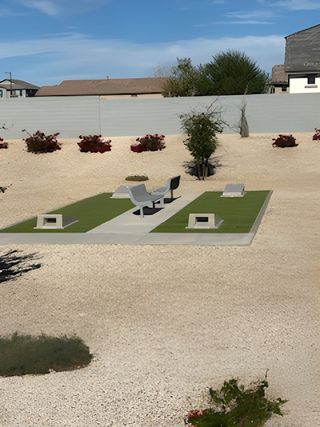 A serene landscaped community area with benches and greenery in Sunrise – Canyon Series by Landsea Homes (Surprise, AZ). 