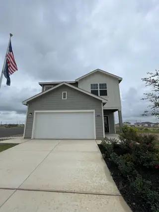 Street view A modern two-story home with a clean driveway in Roosevelt Heights by Starlight Homes (San Antonio, TX).