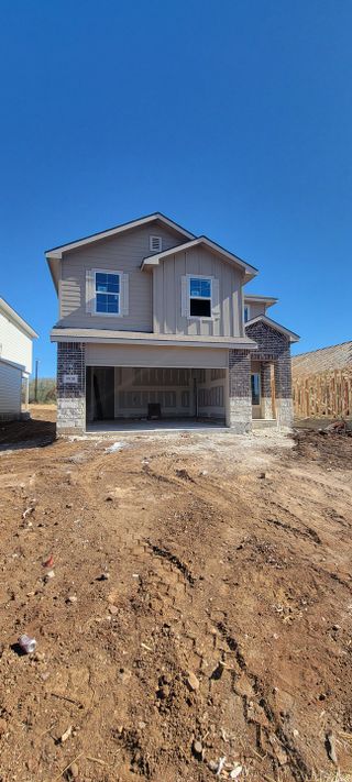 A modern two-story home with stone accents in the Hacienda community by D.R. Horton (San Antonio, TX).