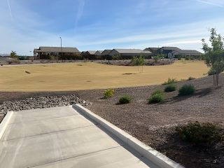 A serene landscape view with open green fields in Bella Vista Farms: Premier by Lennar (San Tan Valley, AZ).