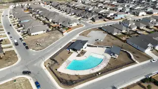 A vibrant community in Overlook at Creekside by Coventry Homes (New Braunfels, TX), featuring a resort-style pool and modern recreational spaces.