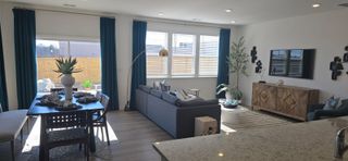  A stylish open-concept living space with large windows, blue curtains, and elegant furnishings in Bethlehem, GA.