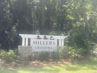 A welcoming entrance to Miller's Crossing by Dream Finders Homes, surrounded by lush greenery in Johns Island, SC.