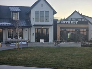 A modern clubhouse with large windows and sleek design in the community of Westerly by SLC Homes (Erie, CO).