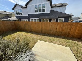 Private backyard at The Poppy at Vista Vera (Georgetown, TX) offers a blank canvas for outdoor living, framed by a new wooden fence.
