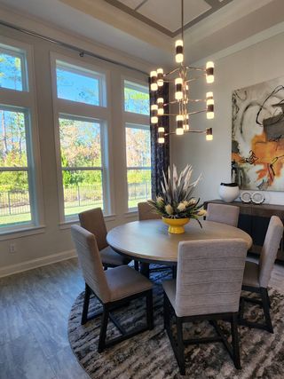 Model Home Beautiful dining area featuring large windows and natural light, perfect for family gatherings.