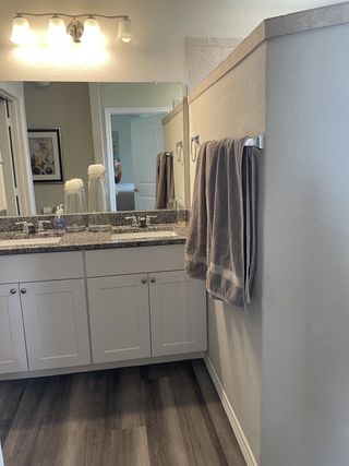 Model Home A spa-like bathroom with dual sinks, granite counters, and elegant lighting.