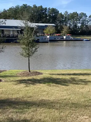 Street view A picturesque lakeside view in ARTAVIA® - 60' by Westin Homes, featuring serene waters and lush greenery in Conroe, TX.