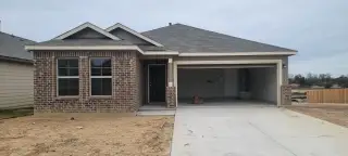 A modern brick home with a two-car garage in Agave by M/I Homes, San Antonio, TX.