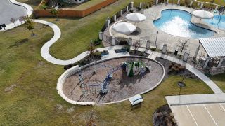 Family fun awaits at Homes by Avi’s Vista Vera (Georgetown, TX) community playground and pool, creating a perfect blend of recreation and relaxation.