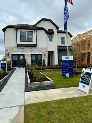 A charming two-story home with modern design and landscaped yard in Lago Mar by Pulte Homes (La Marque, TX).