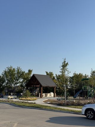 A charming community park with a gazebo and playground in Meadow Park by Ashton Woods (Melissa, TX).