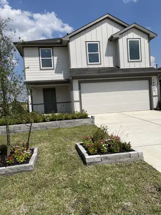 A modern two-story home with landscaped yard in Sunset Valley by D.R. Horton (Hockley, TX).