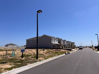 Street view A modern residential street with new homes under clear skies in the Ridgeview community by Landsea Homes (Clermont, FL).