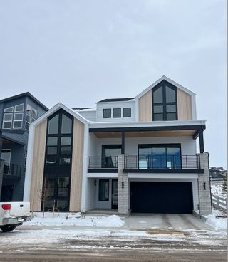 Street view A modern two-story home with large windows and a snowy yard in Lyric at Ridgegate by Infinity Properties (Lone Tree, CO).