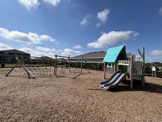 A charming playground with slides and climbing nets in Storey Creek: Estate Collection by Lennar (Kissimmee, FL).