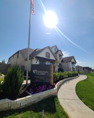 A modern home with lush landscaping and a welcoming path in Painted Tree by Coventry Homes (McKinney, TX).