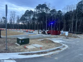 A developing home site in Crescent Townes by Lennar, surrounded by forested landscapes in Raleigh, NC.
