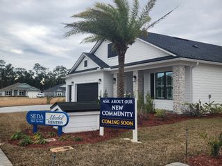 Street view A charming modern home with sleek design in Sandy Ridge by SEDA New Homes, featuring a landscaped yard in Yulee, FL.