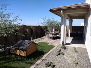 Street view A charming backyard with a covered patio, doghouse, and dining area in Avalon Crossing Inspiration by Lennar (Mesa, AZ).