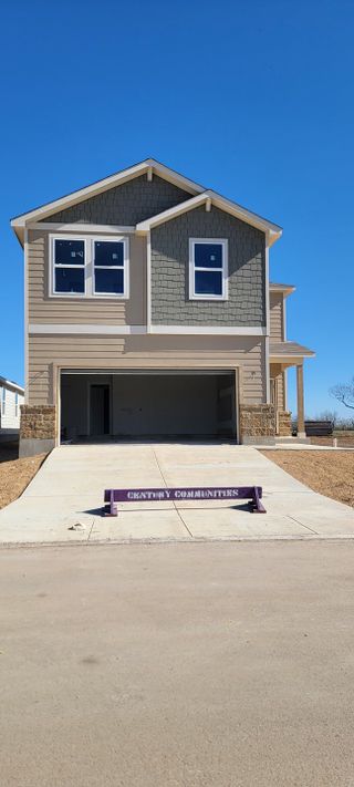 Street view A charming two-story home with a modern facade in Hacienda by Century Communities (San Antonio, TX).
