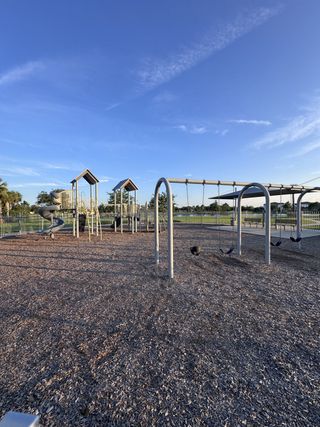 A scenic playground with swings and slides at The Preserve at Bannon Lakes by Pulte Homes in St. Augustine, FL.