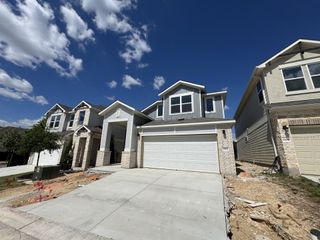 Street view A beautiful home with a crisp exterior and double garage in Messinger Village by Milestone Community Builders (Austin, TX).