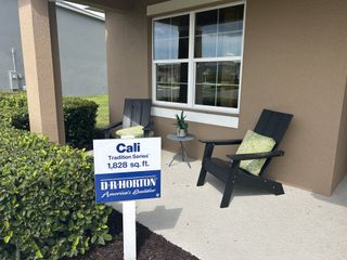 A lovely porch with seating and greenery at Timberwalk by D.R. Horton in Mount Dora, FL, showcasing the Cali Tradition Series.