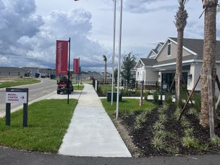 Street view A modern community center with manicured landscaping in Indigo Creek by Taylor Morrison (Ruskin, FL).