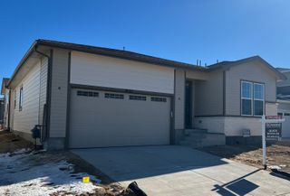 A modern single-story home with a spacious garage in Crossway at Second Creek by Richmond American Homes (Commerce City, CO).