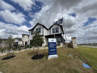 A modern two-story home with manicured landscaping in Patterson Ranch by Pulte Homes (Georgetown, TX).