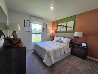 A cozy bedroom with colorful accent walls, modern artwork, and plush bedding for a serene ambiance.