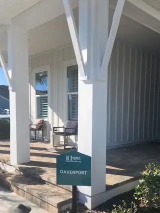Model Home A beautiful home with a well-maintained yard and a welcoming porch in Seven Pines by ICI Homes (Jacksonville, FL).