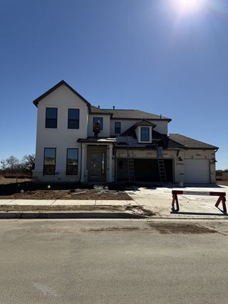 A modern two-story home under construction in Santa Rita Ranch by Taylor Morrison (Liberty Hill, TX).