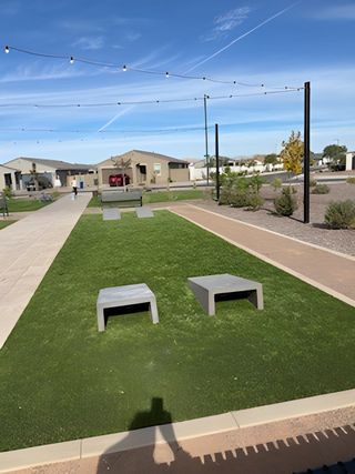 Community Amenities A modern community area with green space and seating in Bella Vista Trails Estate Series by Meritage Homes (San Tan Valley, AZ).