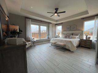 A soft-toned bedroom featuring classic furnishings and stylish wall art.