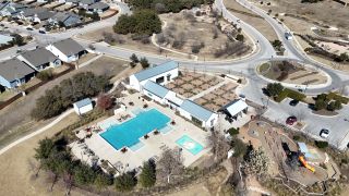 Aerial view of Orchard Ridge's pool and playground by CastleRock Communities in Liberty Hill, TX.