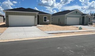 Modern gray homes with clean lines and spacious driveways in Pioneer Ranch: Pioneer Ranch 40's by Lennar (Ocala, FL).