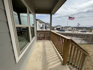 A welcoming porch view in Hunters Ranch by Legend Homes, San Antonio, TX, showcasing a serene neighborhood setting.