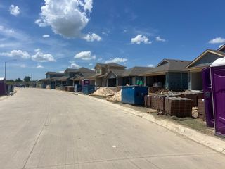 Street view New homes under construction with modern designs in Monarch at the Meadows by D.R. Horton (Denton, TX).