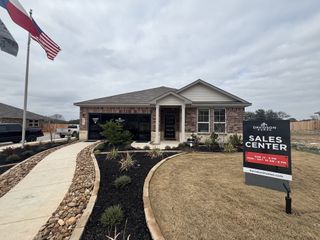 A modern brick home with a two-car garage and a landscaped yard in San Antonio, TX.