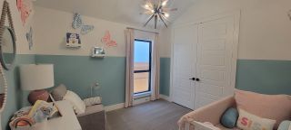 Soft pastel nursery with butterfly wall decor, cozy furnishings, and a calming color scheme for a soothing ambiance.