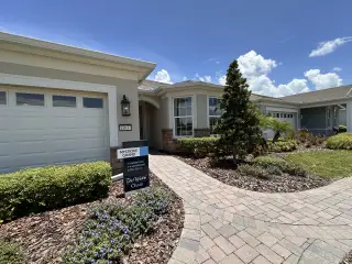 A charming home with manicured landscaping and a welcoming path in Del Webb Oasis by Del Webb (Winter Garden, FL).