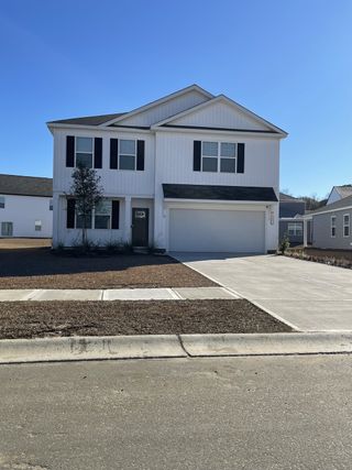 A modern two-story home with a clean facade and double garage in Carolina Groves by D.R. Horton (Moncks Corner, SC).